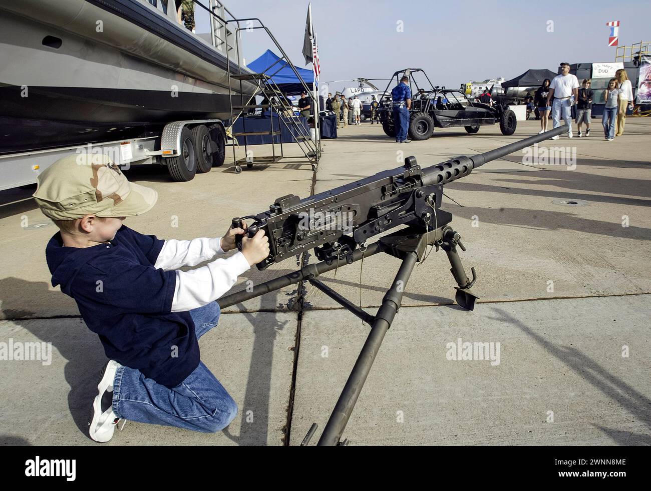 A young boy checks out the machine guns on display at the Miramar Air Show in San Diego, CA. Stock Photo