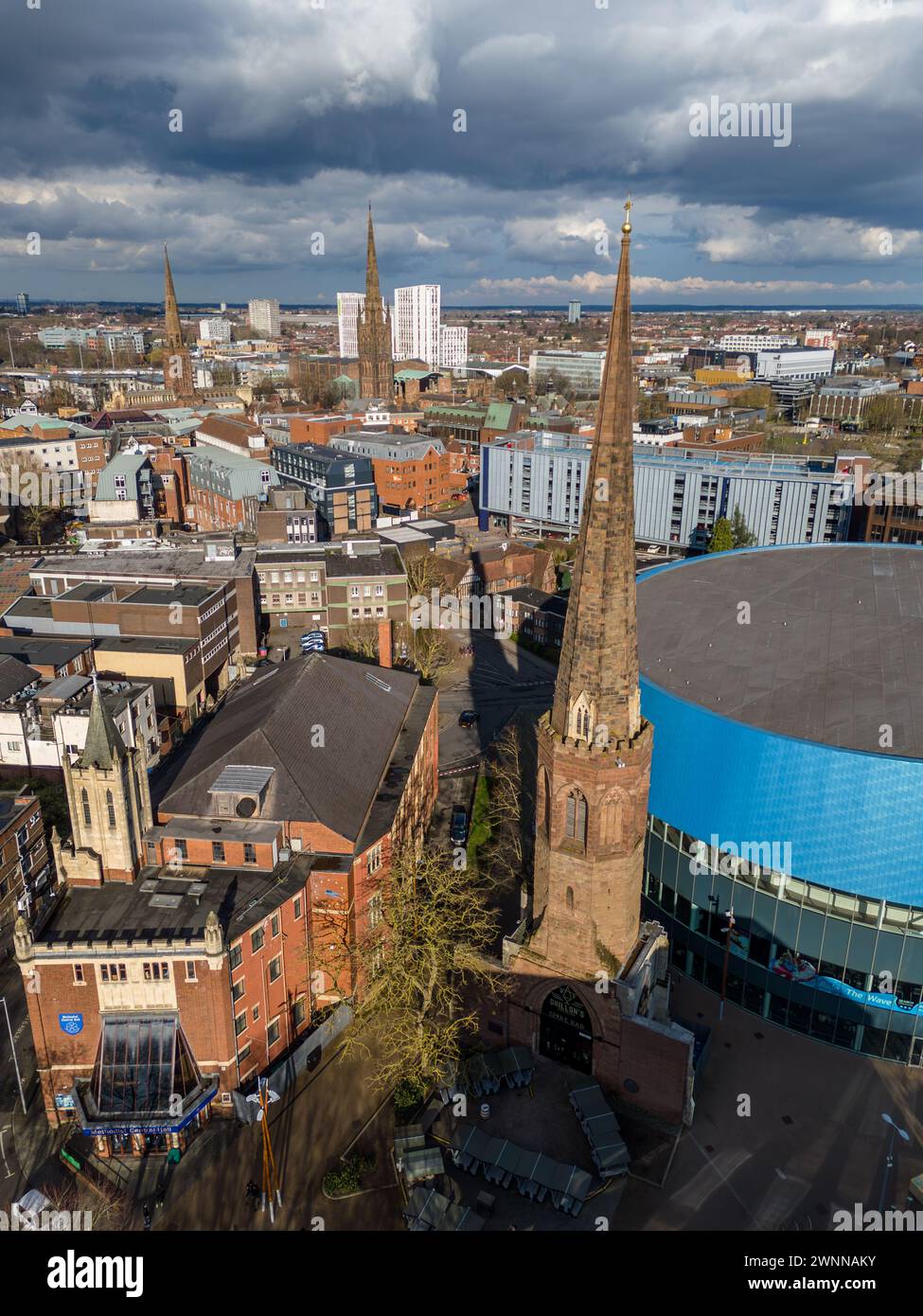 Aerial shot capturing the iconic spires and architecture of coventry, uk under a dynamic sky Stock Photo