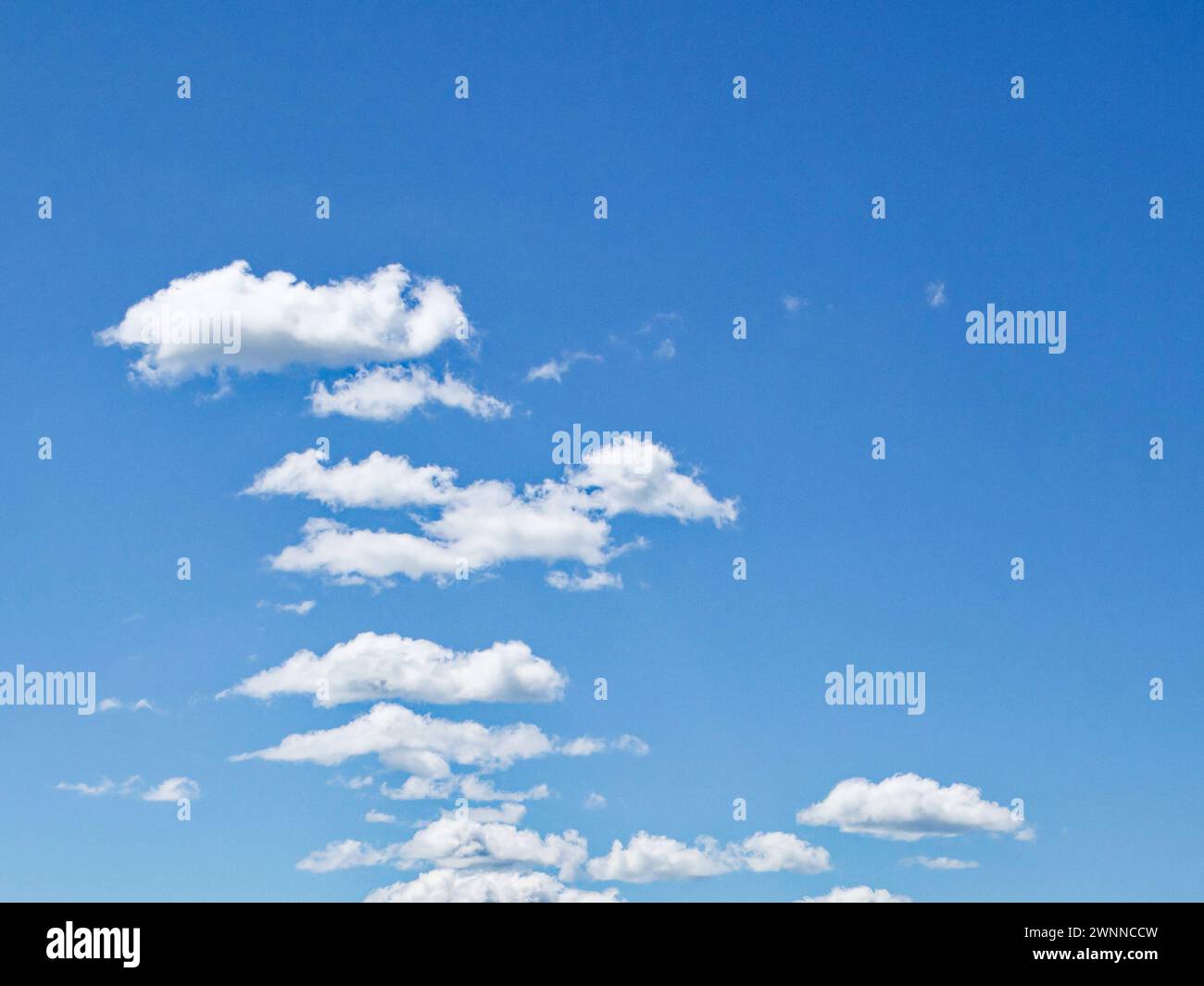A clear sky with scattered white clouds Stock Photo - Alamy
