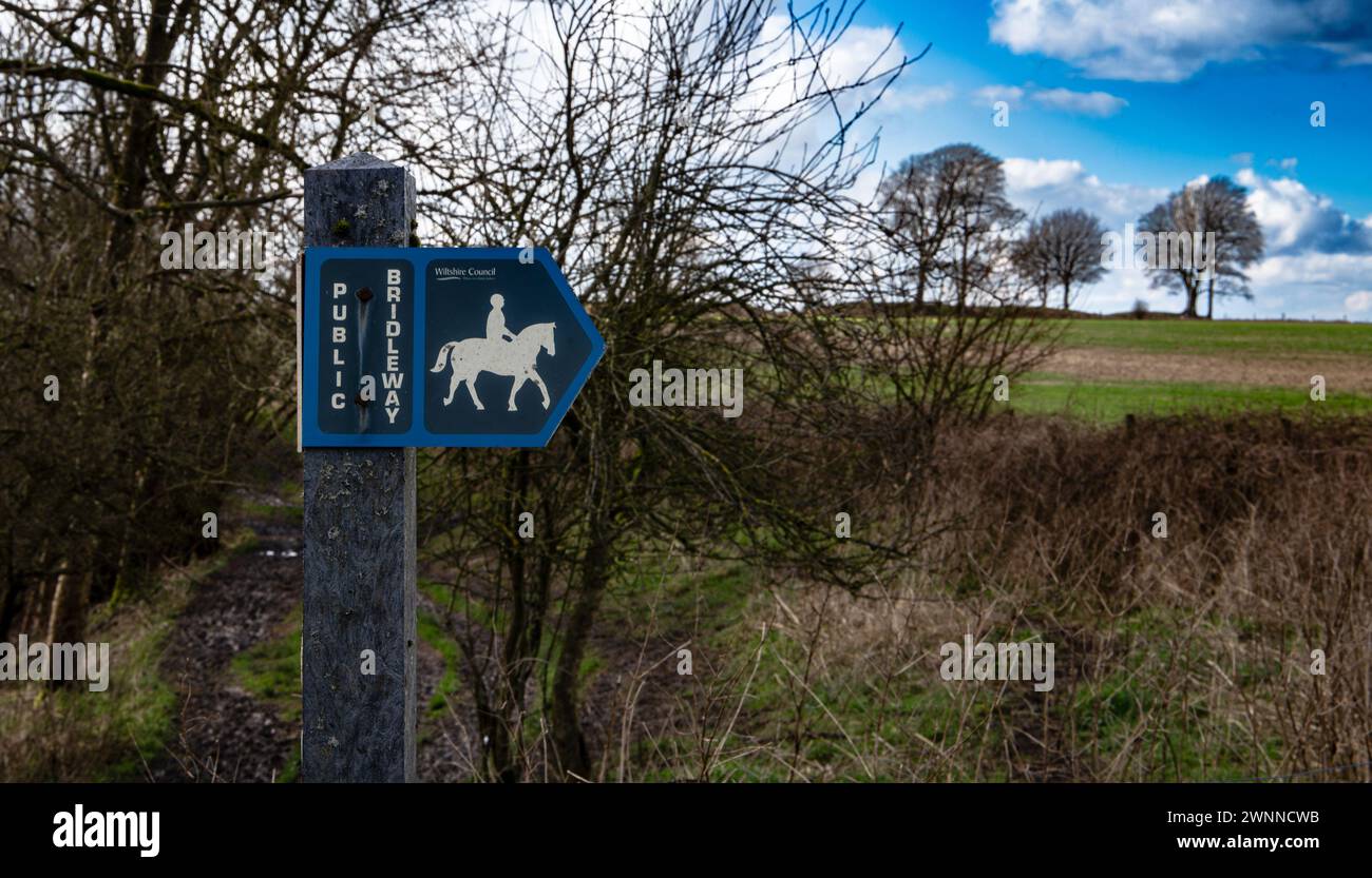 Public bridleway sign for horse riders set against rural landscape with ...