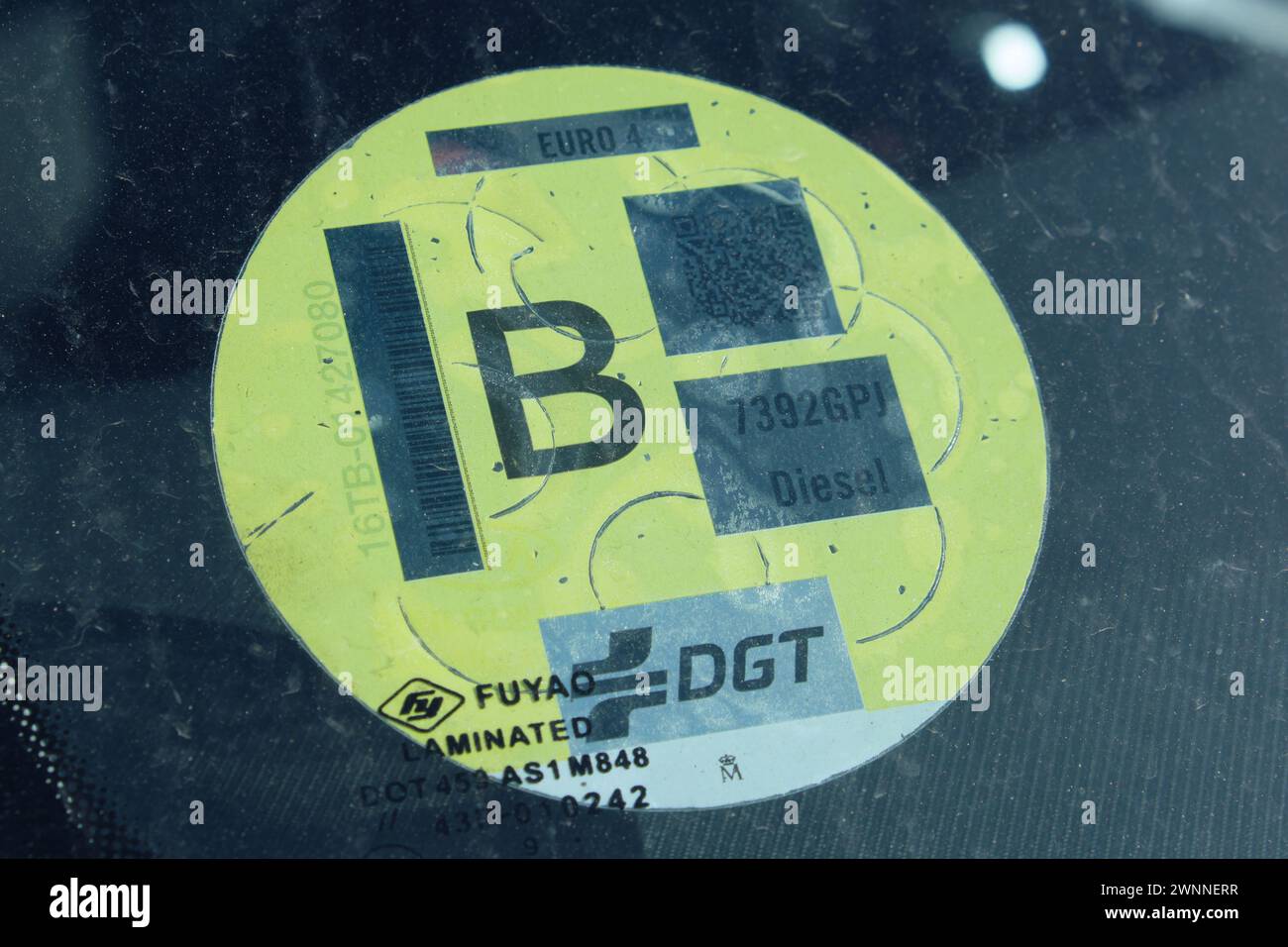 Environmental label to classify vehicles according to their energy efficiency affixed to the windscreen of a car. Yellow B label. Stock Photo