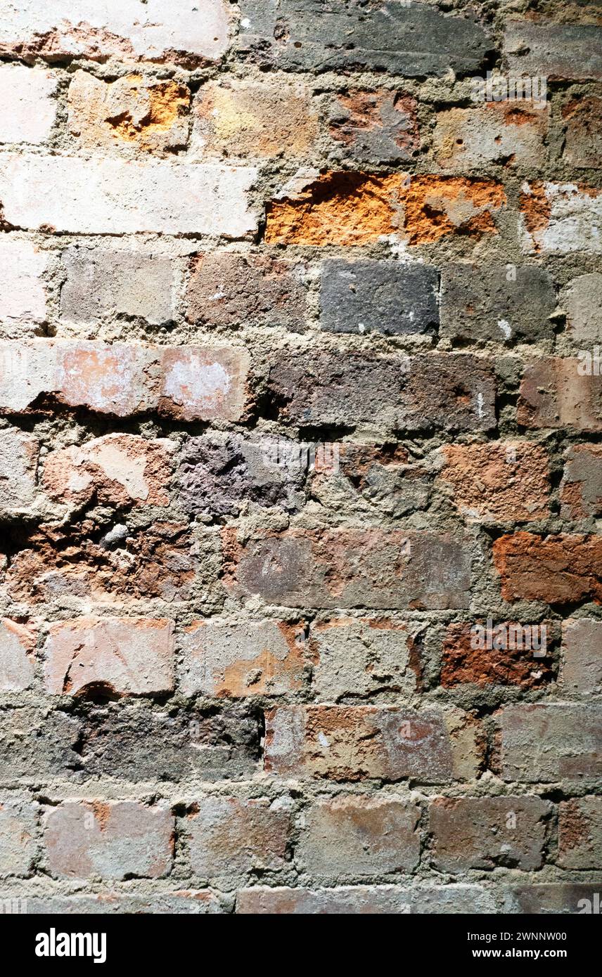 Crumbling Indoor Vintage Brick Wall with Red Bricks Stock Photo