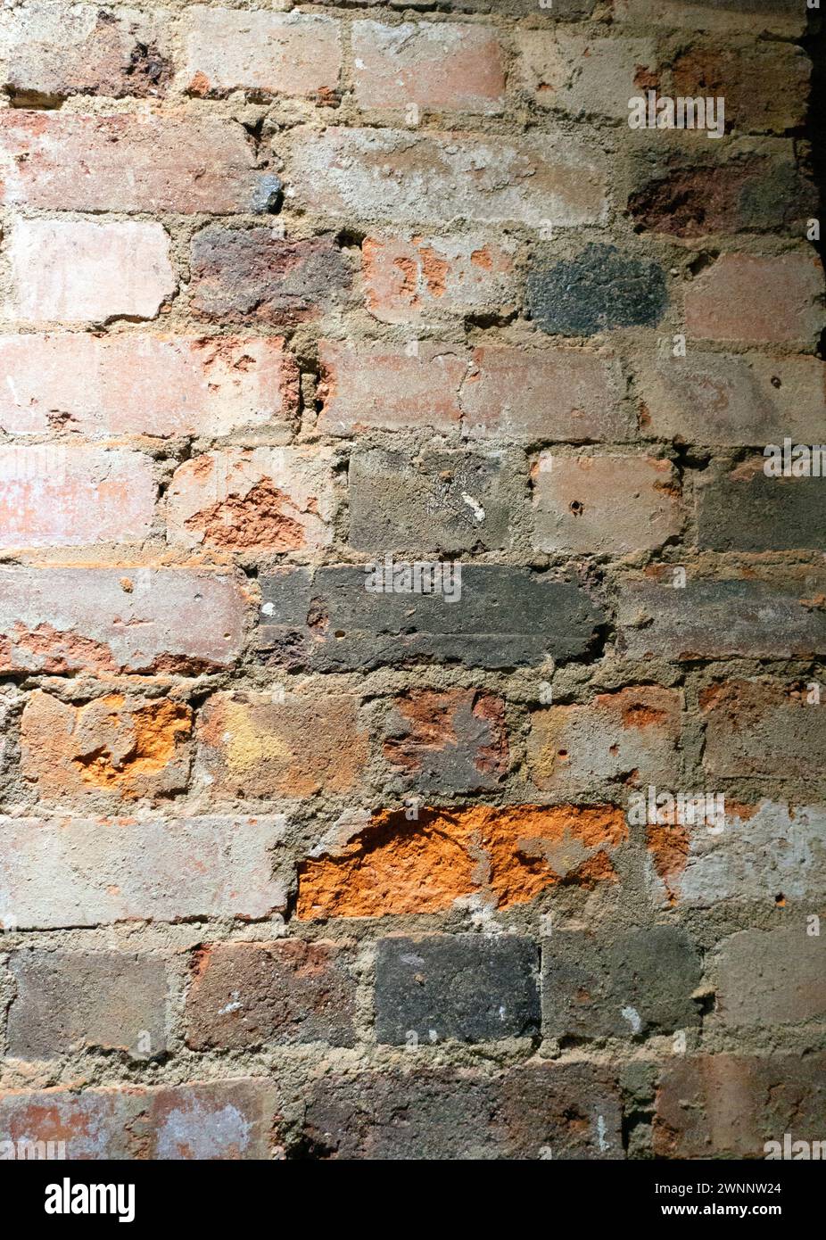 Crumbling Indoor Vintage Brick Wall with Red Bricks Stock Photo