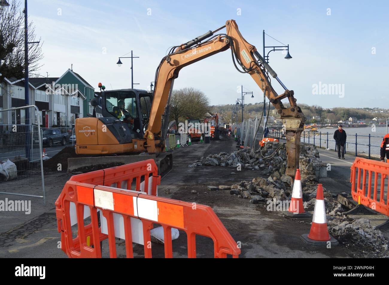 An excavator at work on the Mumbles Coastal Protection project. Mumbles, Swansea, Wales, United Kingdom. 19th February 2024 Stock Photo