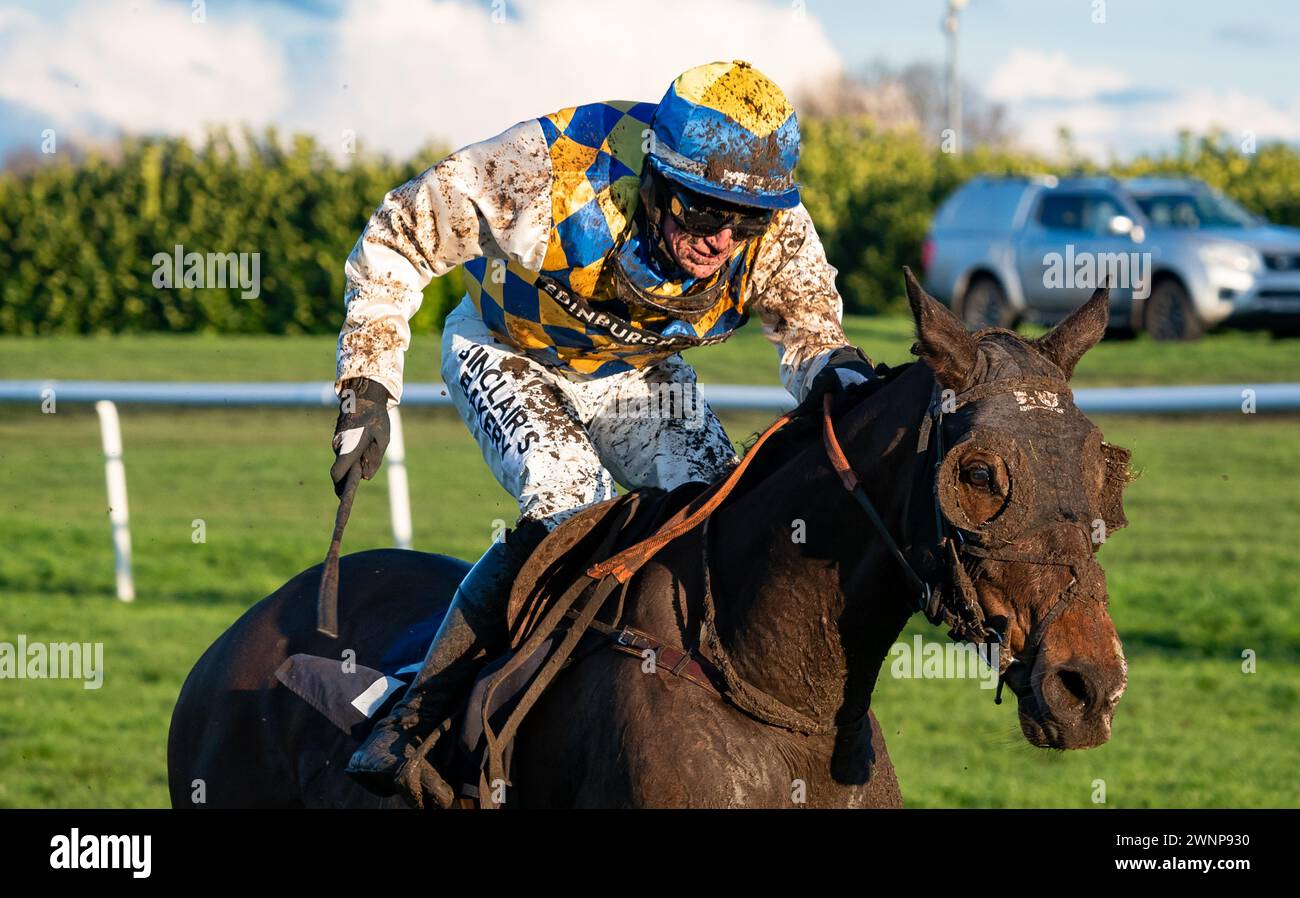 Cuban Cigar and Alan Doyle return mud-splattered after finishing third at Doncaster Racecourse, 02/03/2024. Credit JTW Equine Images / Alamy. Stock Photo