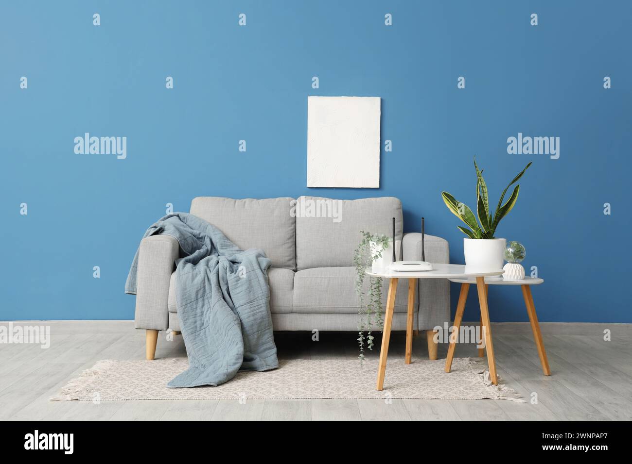 Interior of living room with sofa and wi-fi router on table Stock Photo ...