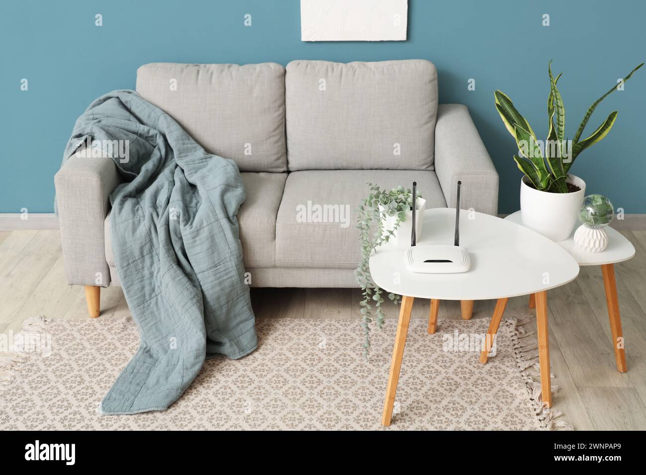 Interior of living room with sofa and wi-fi router on table Stock Photo ...