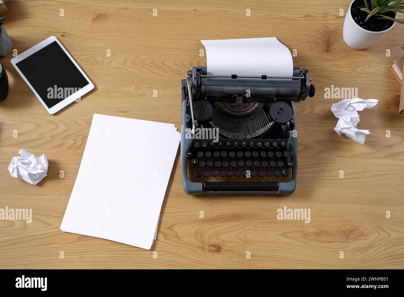 Vintage typewriter with paper sheets on wooden table, top view Stock Photo
