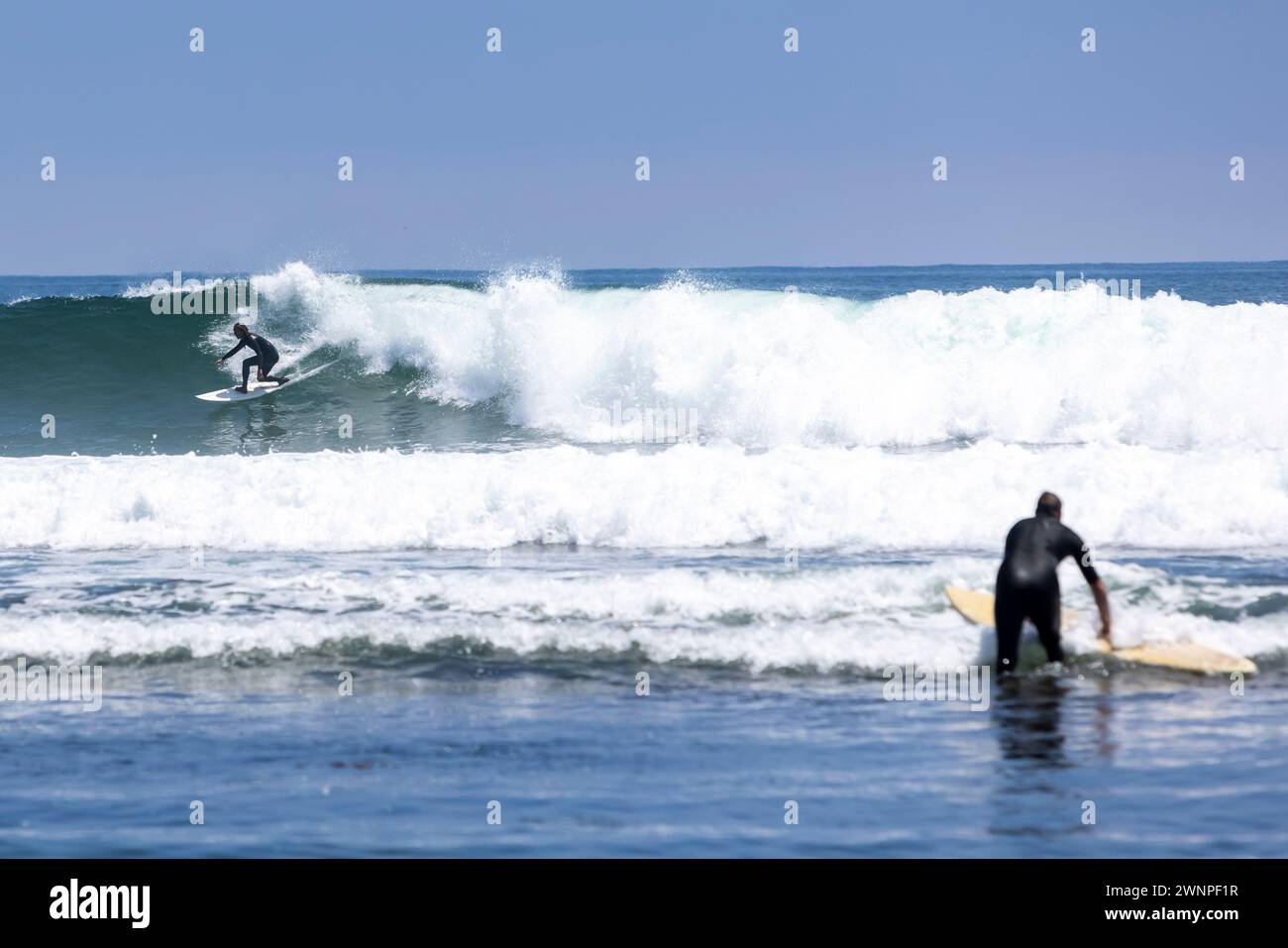 Surfers take to the waves near 3rd Point at Malibu’s Surfrider Beach in Malibu, California. Stock Photo