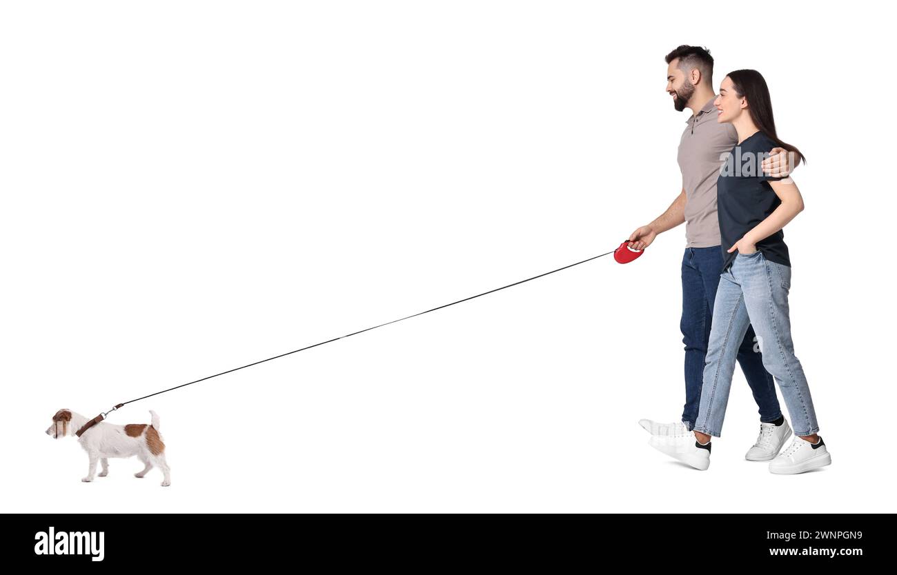 Happy couple walking with dog on white background Stock Photo - Alamy