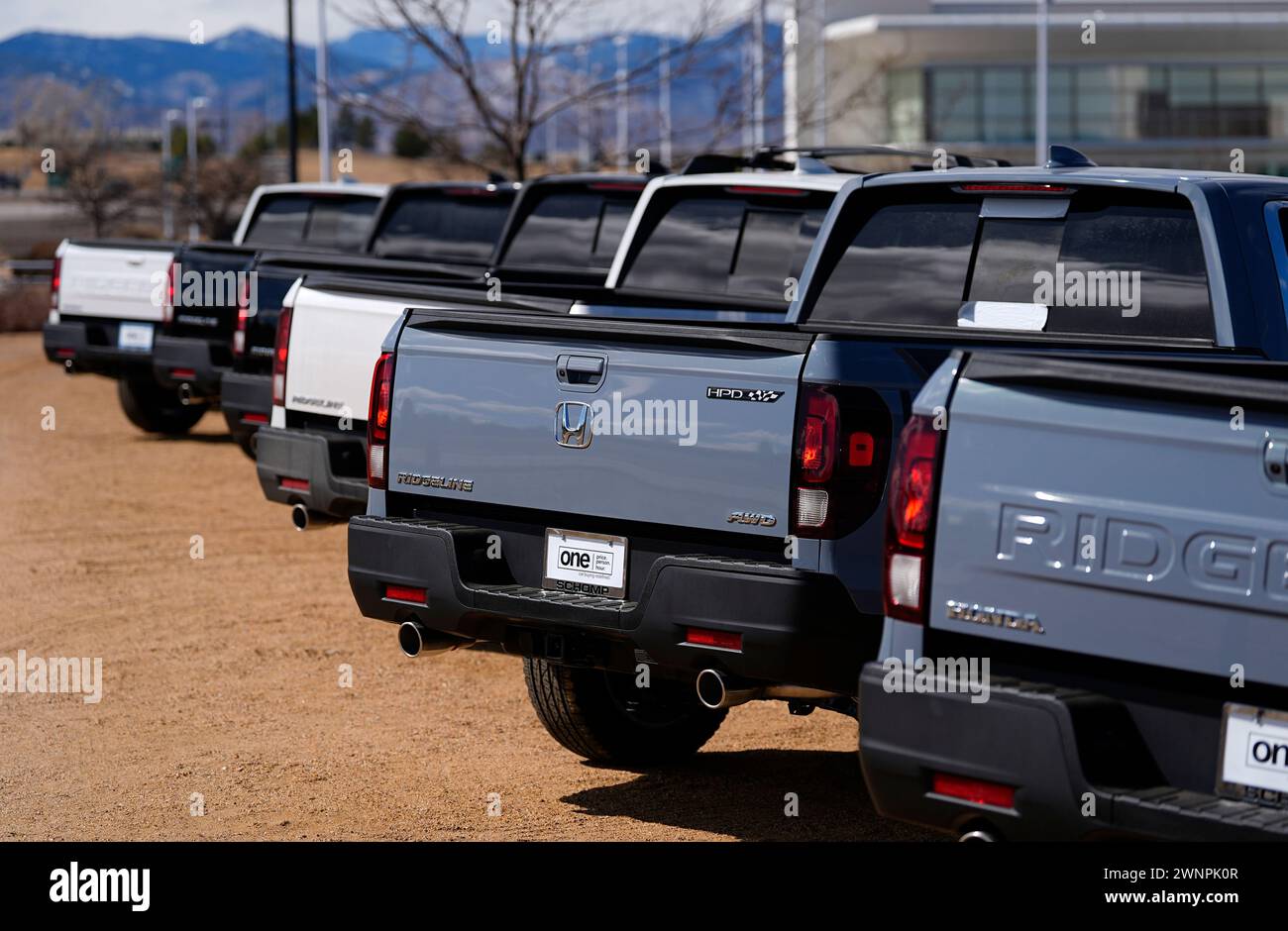 Unsold 2024 Ridggeline pickup trucks sit outside a Honda dealership