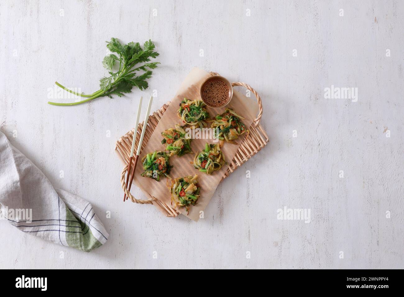 This is a delicious and savory Korean mugwort pancake (쑥갓전). The pancake is crispy on the outside and soft and fluffy on the inside. Stock Photo