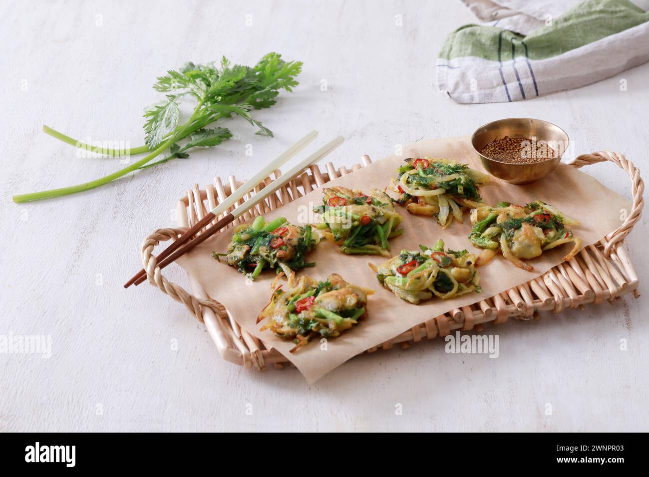 This is a delicious and savory Korean mugwort pancake (쑥갓전). The pancake is crispy on the outside and soft and fluffy on the inside. Stock Photo