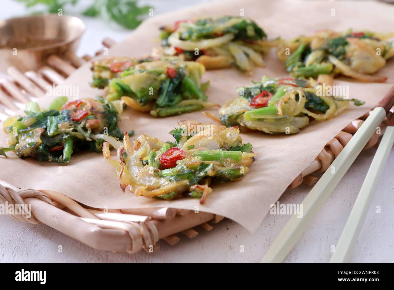 This is a delicious and savory Korean mugwort pancake (쑥갓전). The pancake is crispy on the outside and soft and fluffy on the inside. Stock Photo