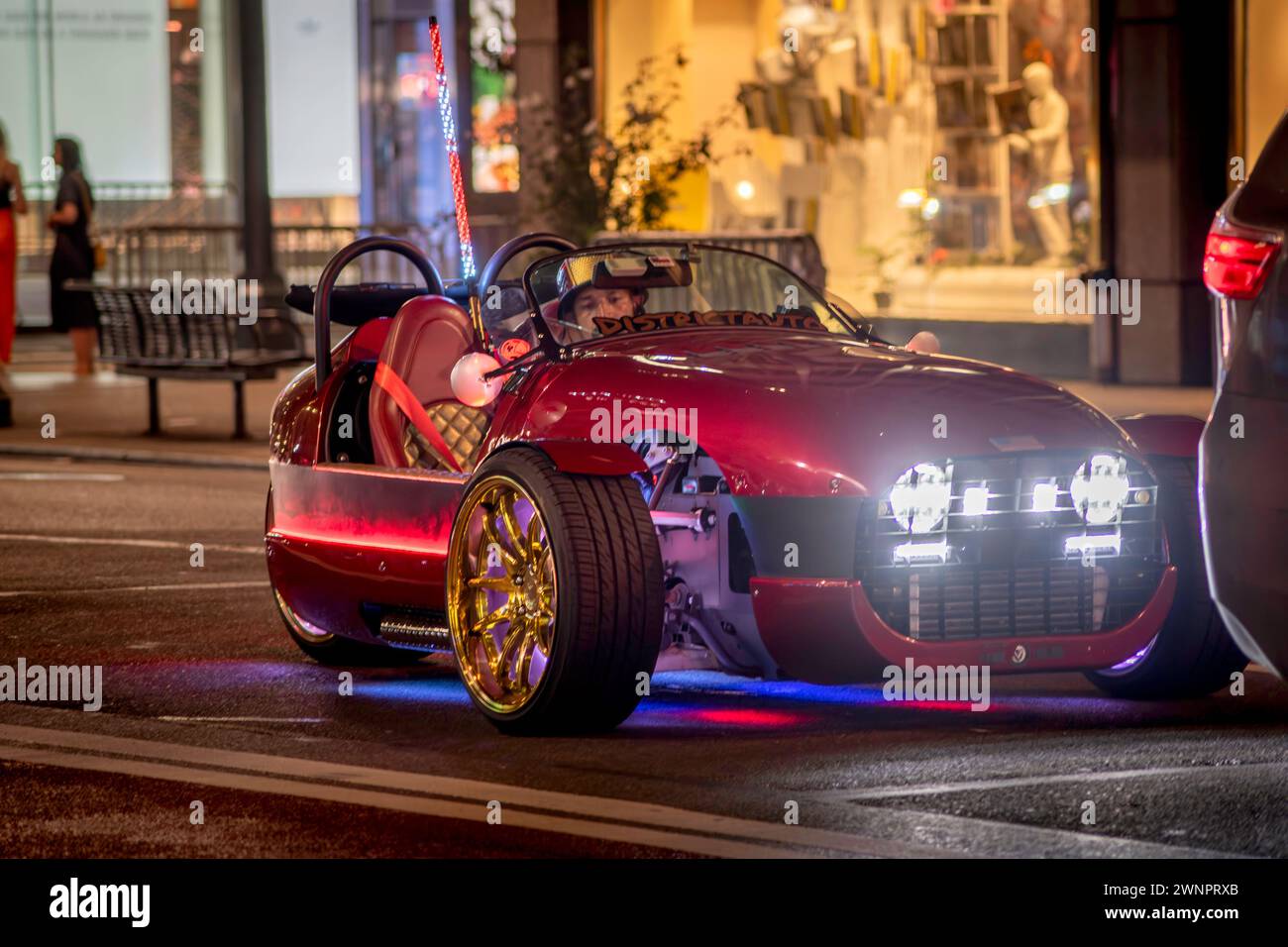 Three wheeled car on a street in New York at night Stock Photo