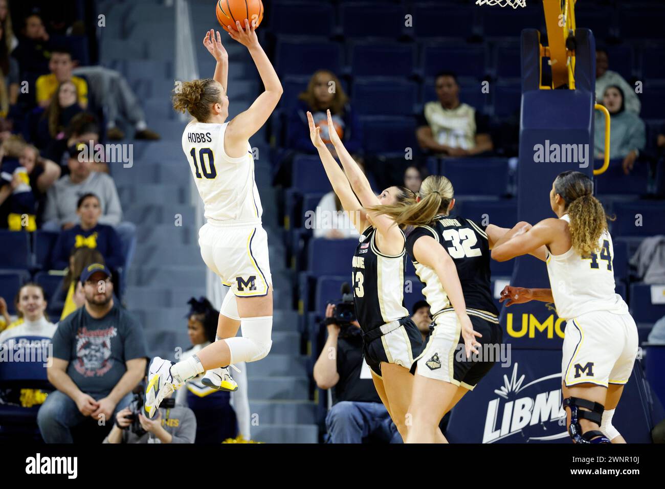 Michigan guard Jordan Hobbs (10), left, shoots against Purdue guard ...