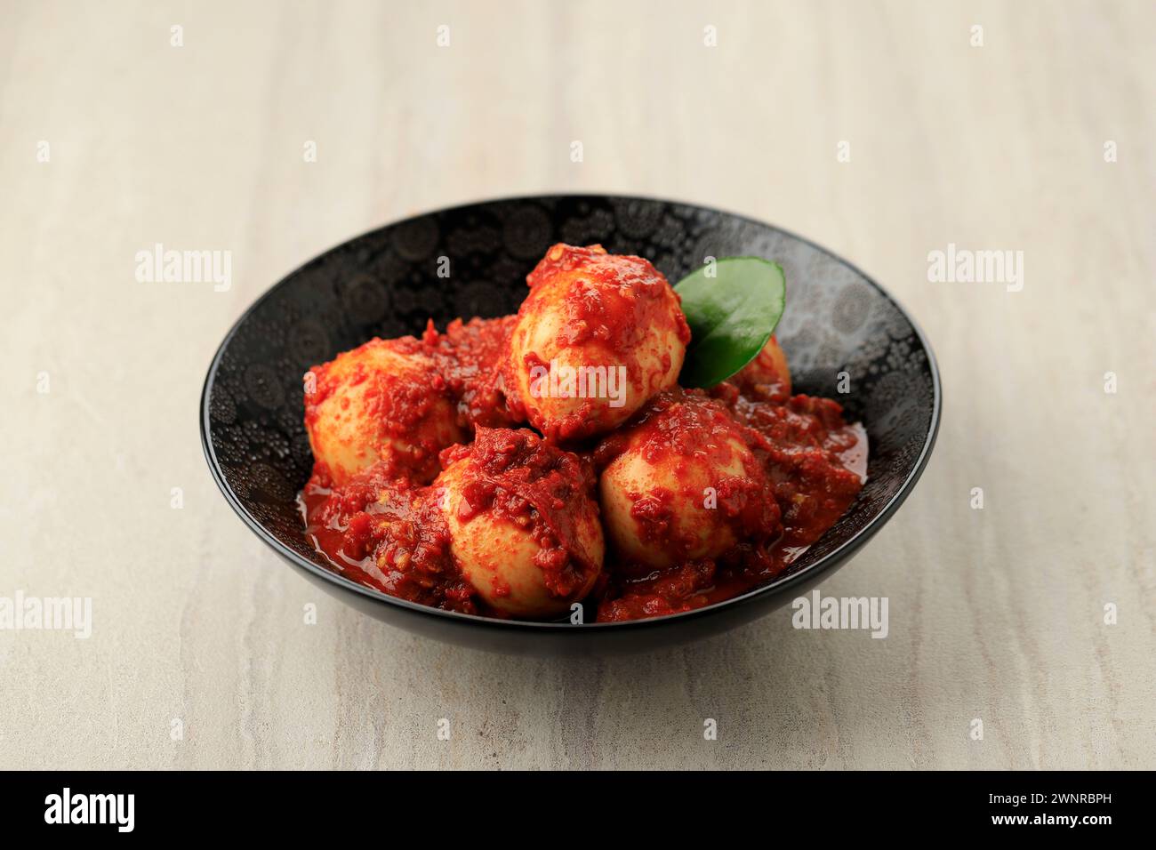 Telur Bumbu Balado or Spicy Boiled Egg. Indonesian Popular Daily Side Dish Made from Egg Coated Stir Fry in Chilli Paste Sauce. Stock Photo