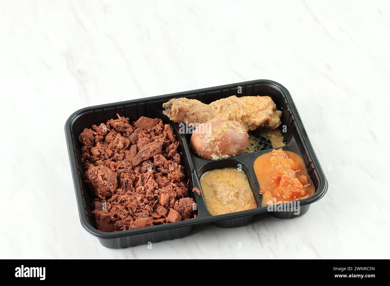 Gudeg Jogja Komplit, Concept Indonesian Food on the Go or Nasi Kotak. Isolated on White Stock Photo
