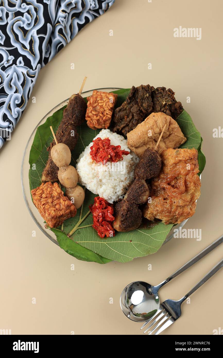 Nasi Jamblang or Nasi Campur Cirebon, Steamed Rice Wrapped with Teak Leaves and Serve with Various Side Dish Stock Photo