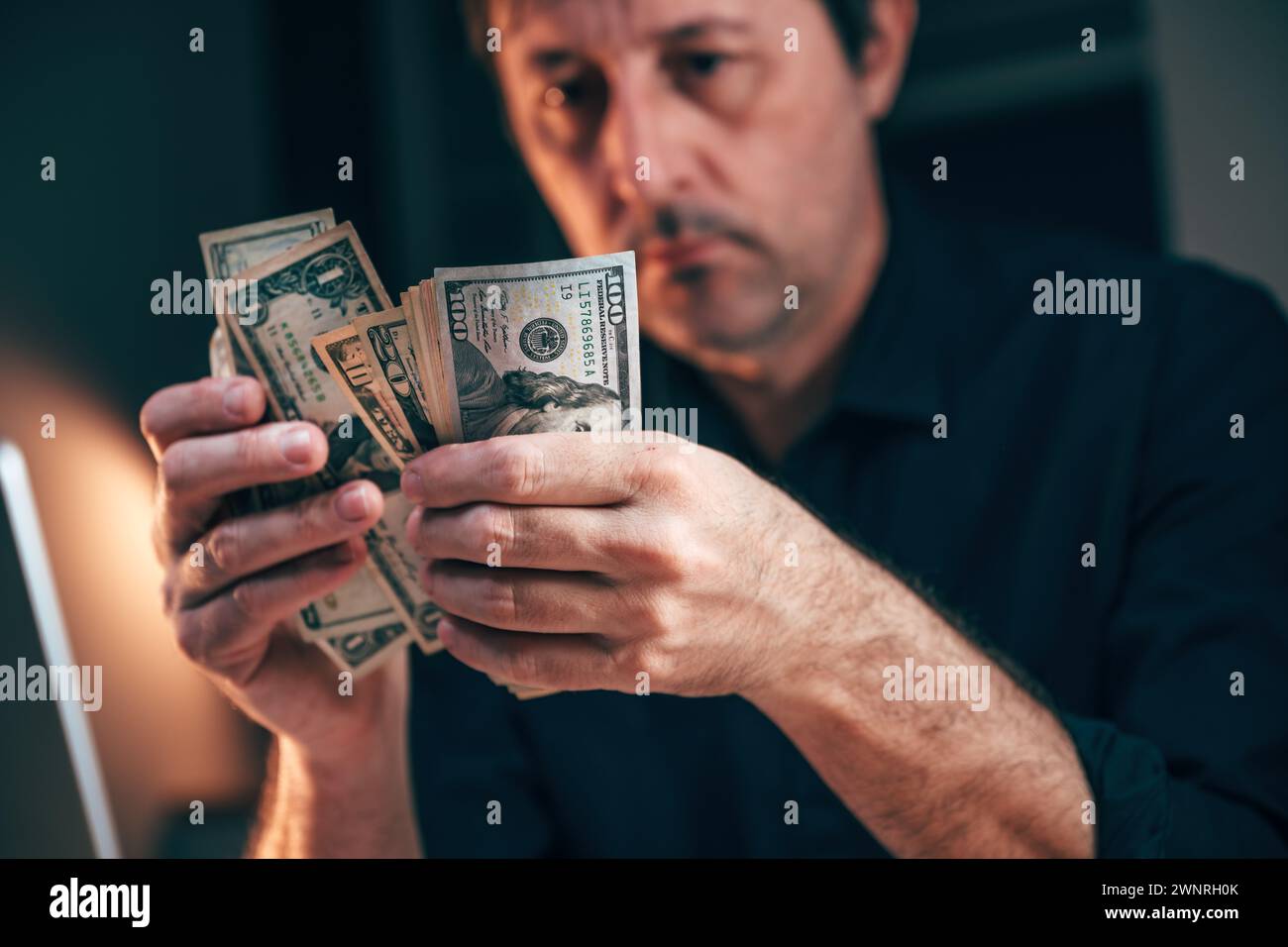 Entrepreneur counting american dollars at office desk, selective focus Stock Photo