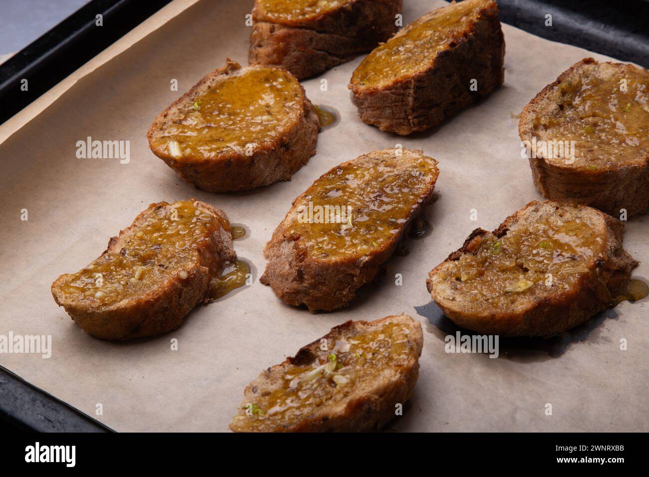 Homemade Honey-Glazed Whole Wheat Toasts on Baking Sheet. Stock Photo