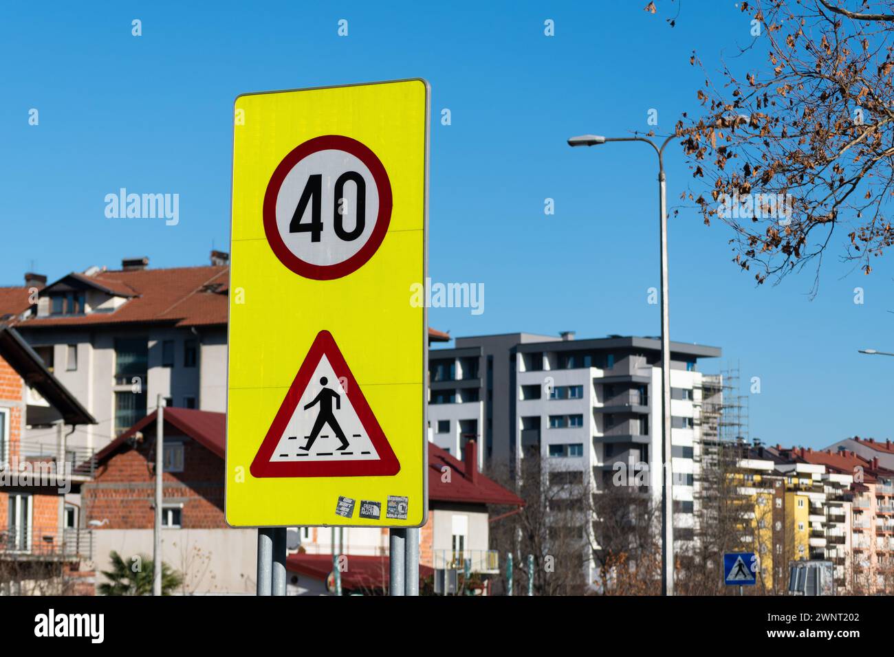 Crosswalk and speed limit signs on yellow background, warning sign Stock Photo