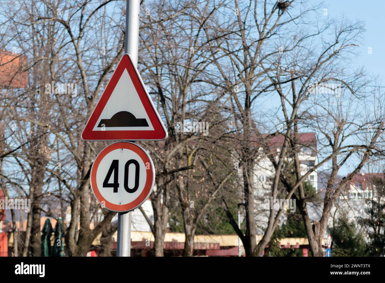 Traffic signs close up, speed bump or bumpy road and speed limit 40 km/h Stock Photo