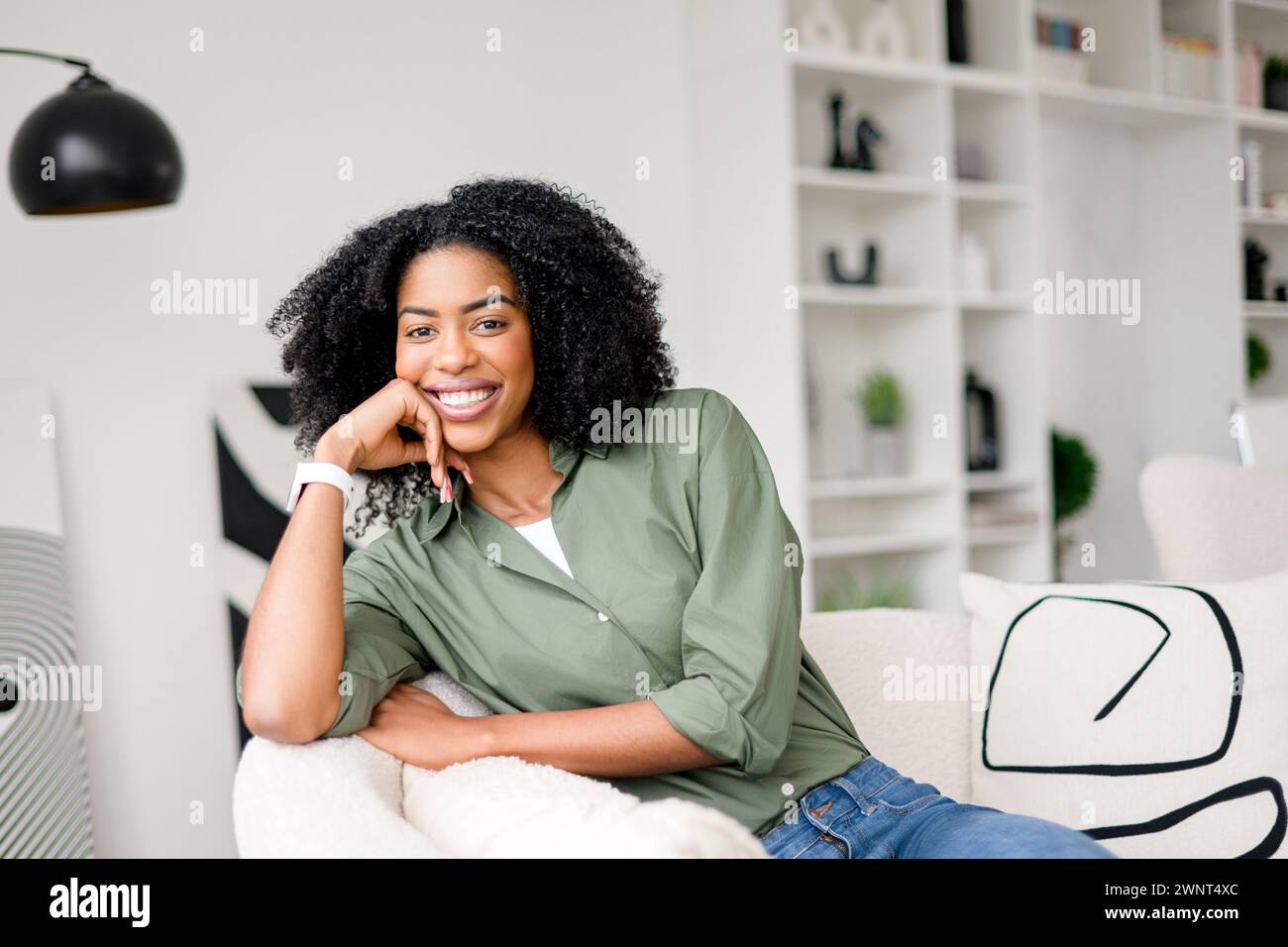 Woman comfortably seated on couch hi-res stock photography and images ...