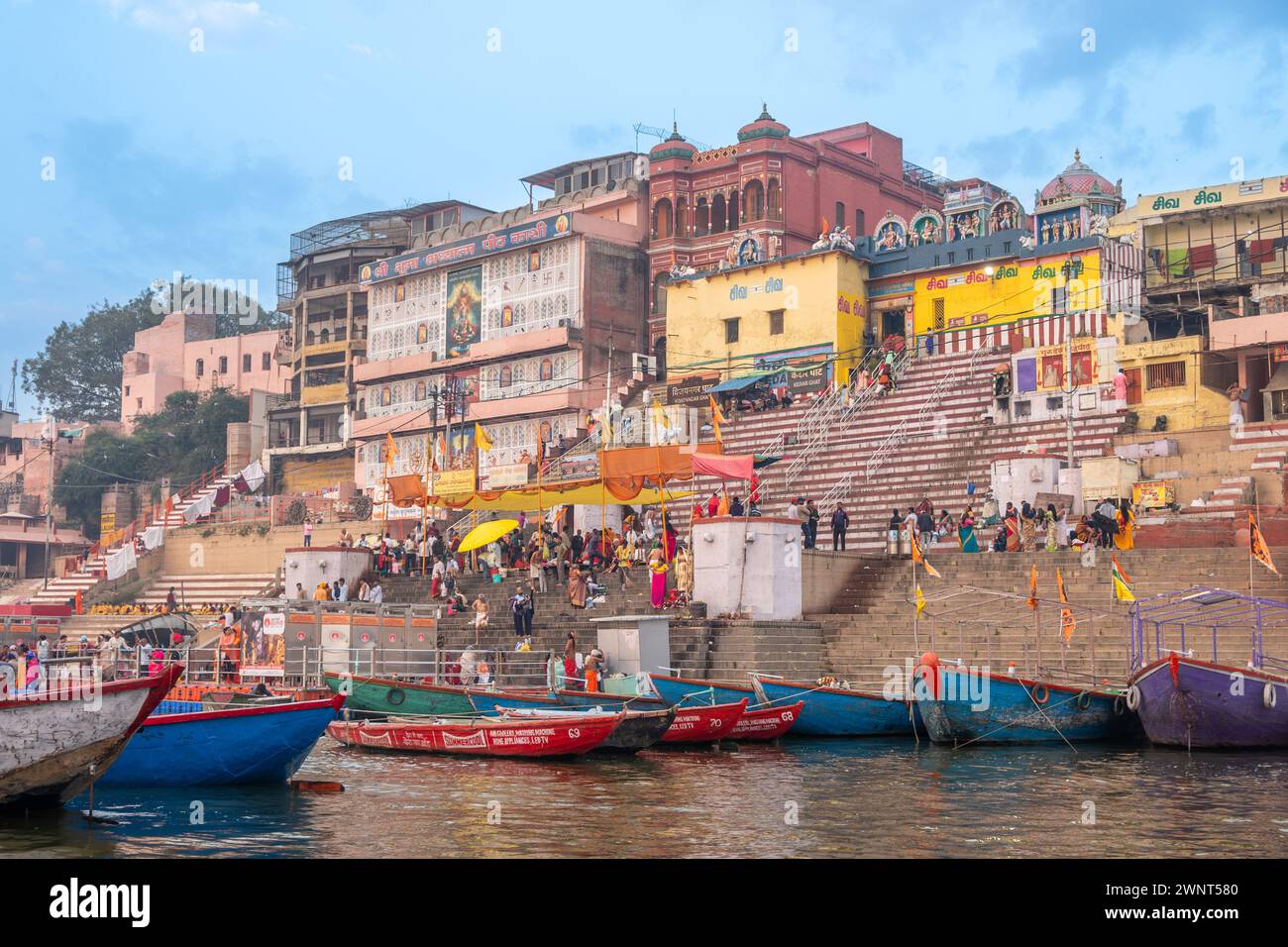 Varanasi, India - February 24, 2024:  people follow their deat cult procession at the border of holy river ganges at a gath in Varanasi. Stock Photo