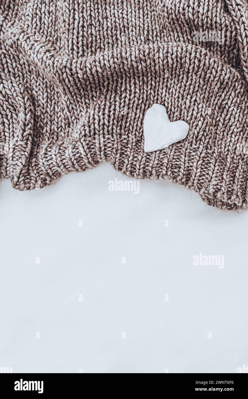 Knitted Beige Pullover with Little White Heart Stock Photo