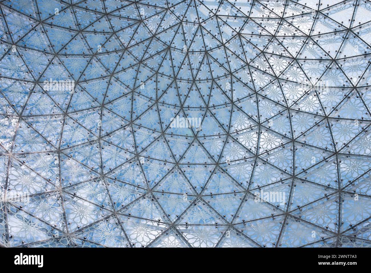 Glass ceiling in blue sky sunlight, abstract. Glass roof of the building. Geometrical ceiling, limpid round ceiling. Glass roof of the building over b Stock Photo