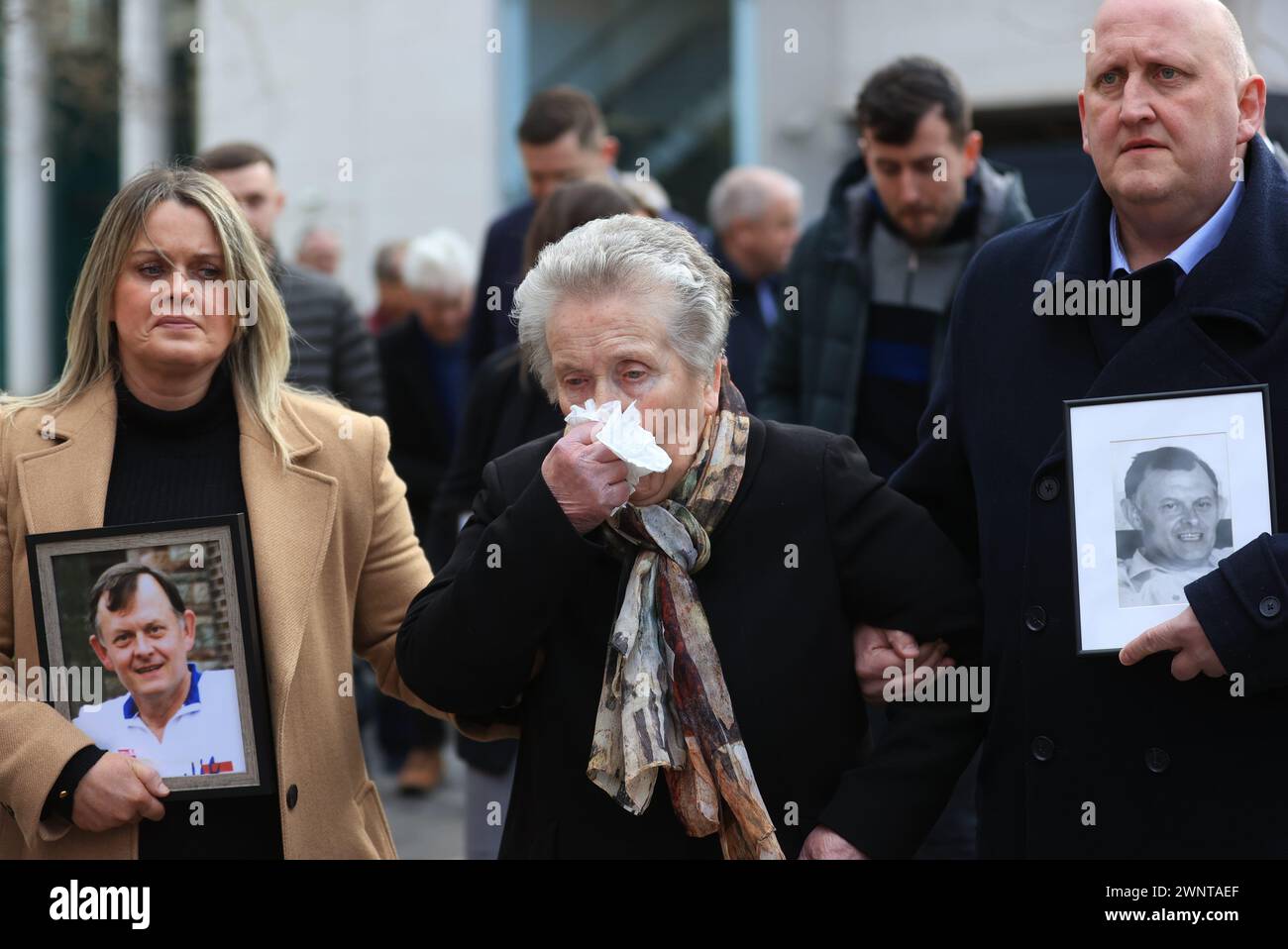 The family of Sean Brown (left to right) daughter Clare Loughran, widow Bridie Brown, and son Sean Brown, outside the Royal Courts of Justice, Belfast, for the announcement on the public interest immunity (PII) process at the inquest hearing for GAA official Sean Brown, who was abducted and killed by loyalists as he locked the gates at Bellaghy Wolfe Tones Club in Co Londonderry in May 1997.  Picture date: Monday March 4, 2024. Stock Photo