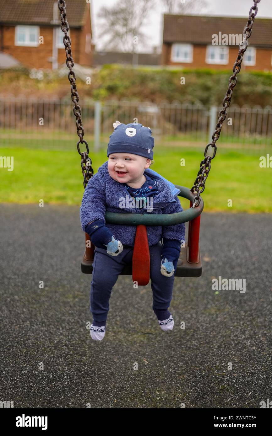 Image ©Licensed to Parsons Media.10/02/2024. A one year old using a swing in a playground in Hertfordshire. Picture by Andrew Parsons / Parsons Media Stock Photo