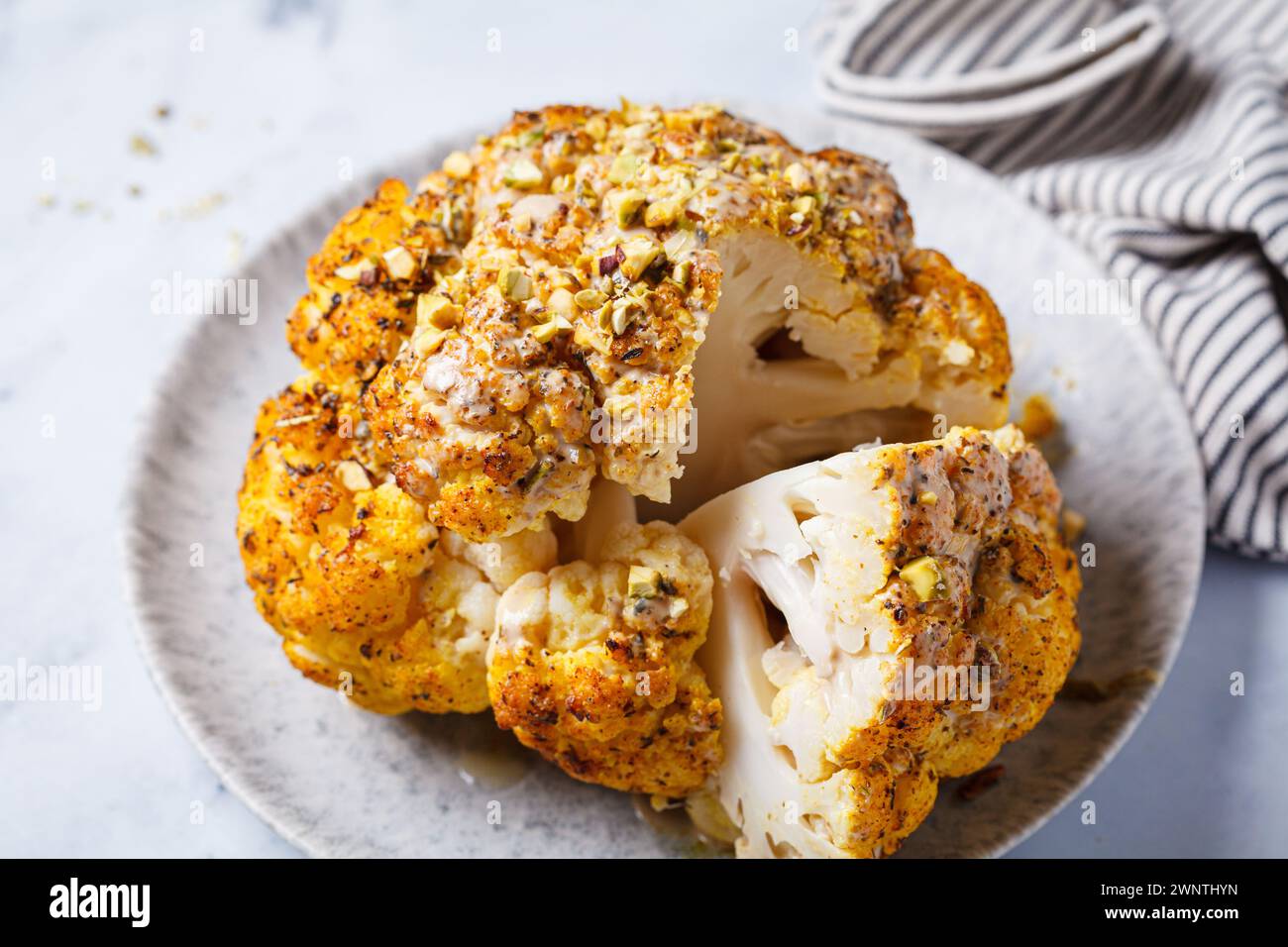 Spicy baked cauliflower with tahini dressing and pistachios. Vegan ...