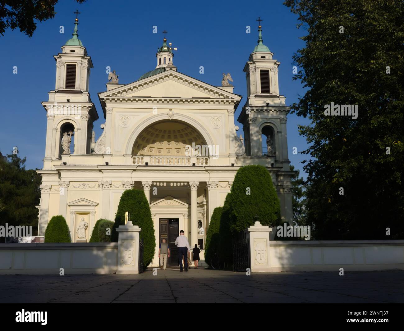 Wilanow Saint Anne's Church, people go to the afternoon mass Stock Photo