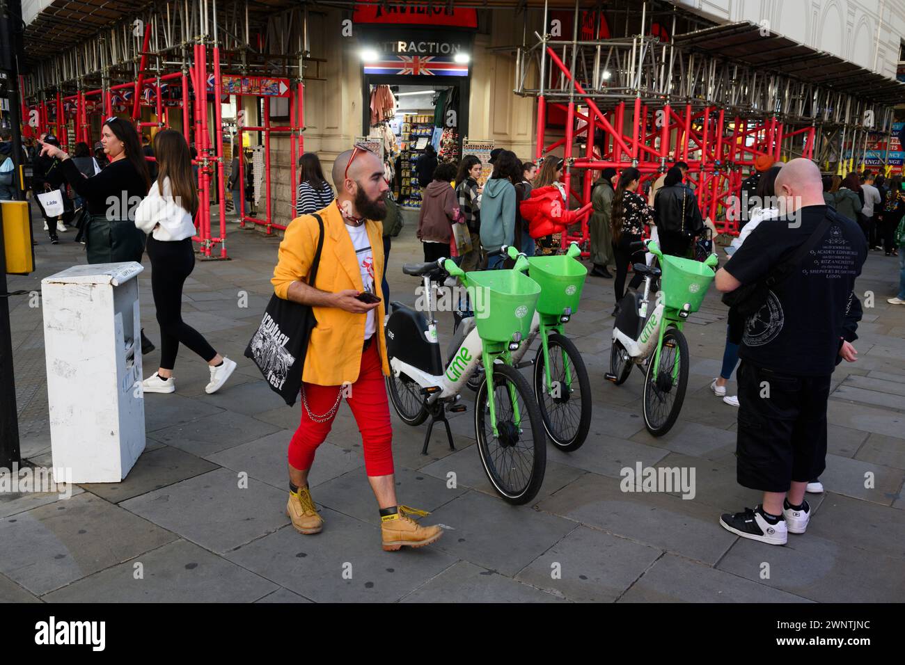 Parked Lime e-bikes at the junction of Shaftesbury Avenue and Piccadilly Circus London, UK.  29 Sep 2023 Stock Photo