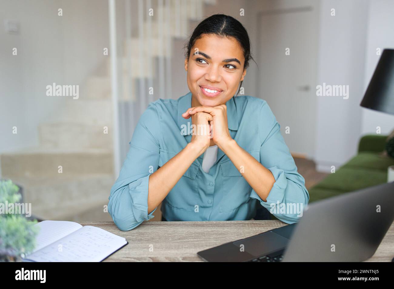 Entrepreneur young woman dreaming while using laptop in home office ...