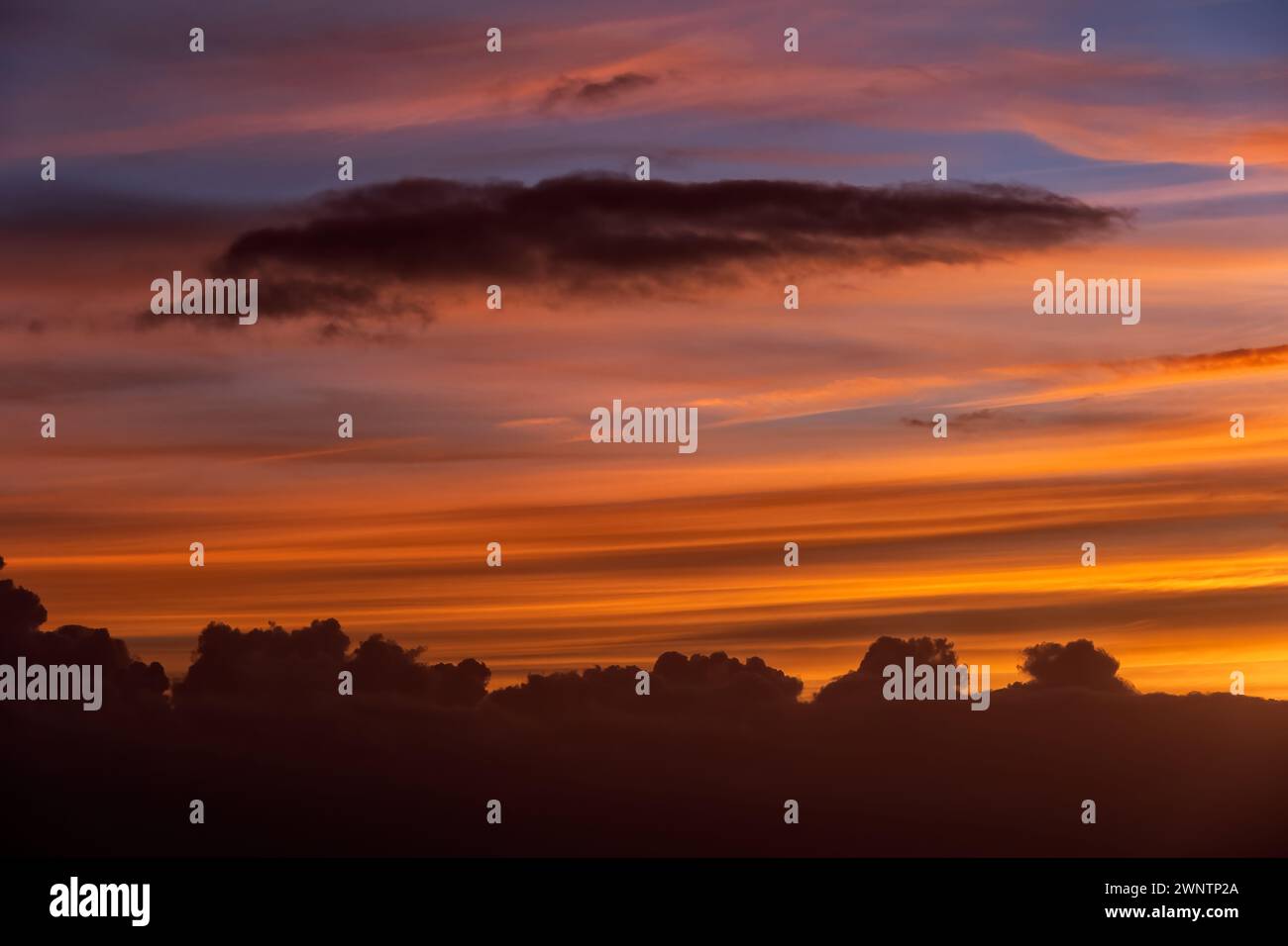 Sky at sunset with smooth and stormy clouds, natural cloudscape background. Stock Photo