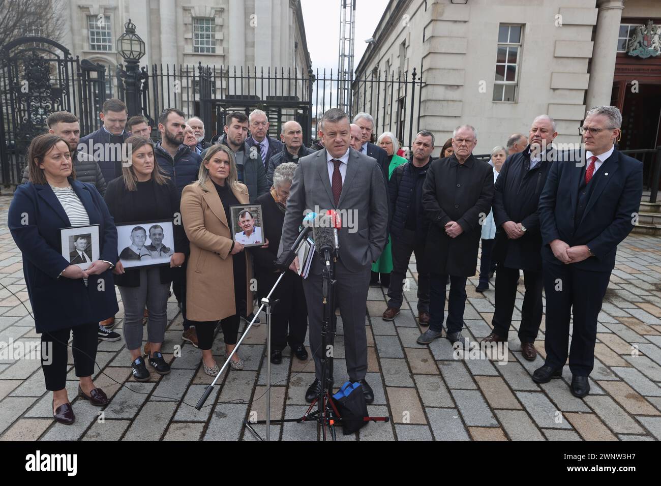 RETRANSMITTING AMENDING CAPTION Removing reference to coroner. Solicitor Niall Murphy, surrounded by members of Sean Brown's family, speaks to the media outside the Royal Courts of Justice, Belfast, for the announcement on the public interest immunity (PII) process at the inquest hearing for GAA official Sean Brown, who was abducted and killed by loyalists as he locked the gates at Bellaghy Wolfe Tones Club in Co Londonderry in May 1997. Picture date: Monday March 4, 2024. Stock Photo