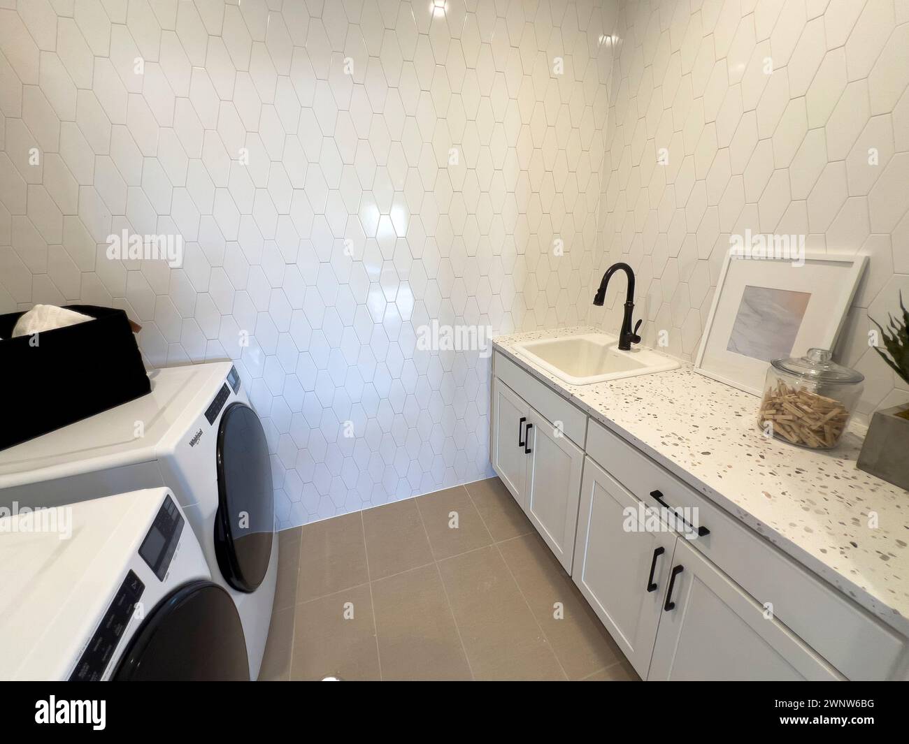 Modern Laundry Room with High-Efficiency Appliances and Chic Decor Stock Photo