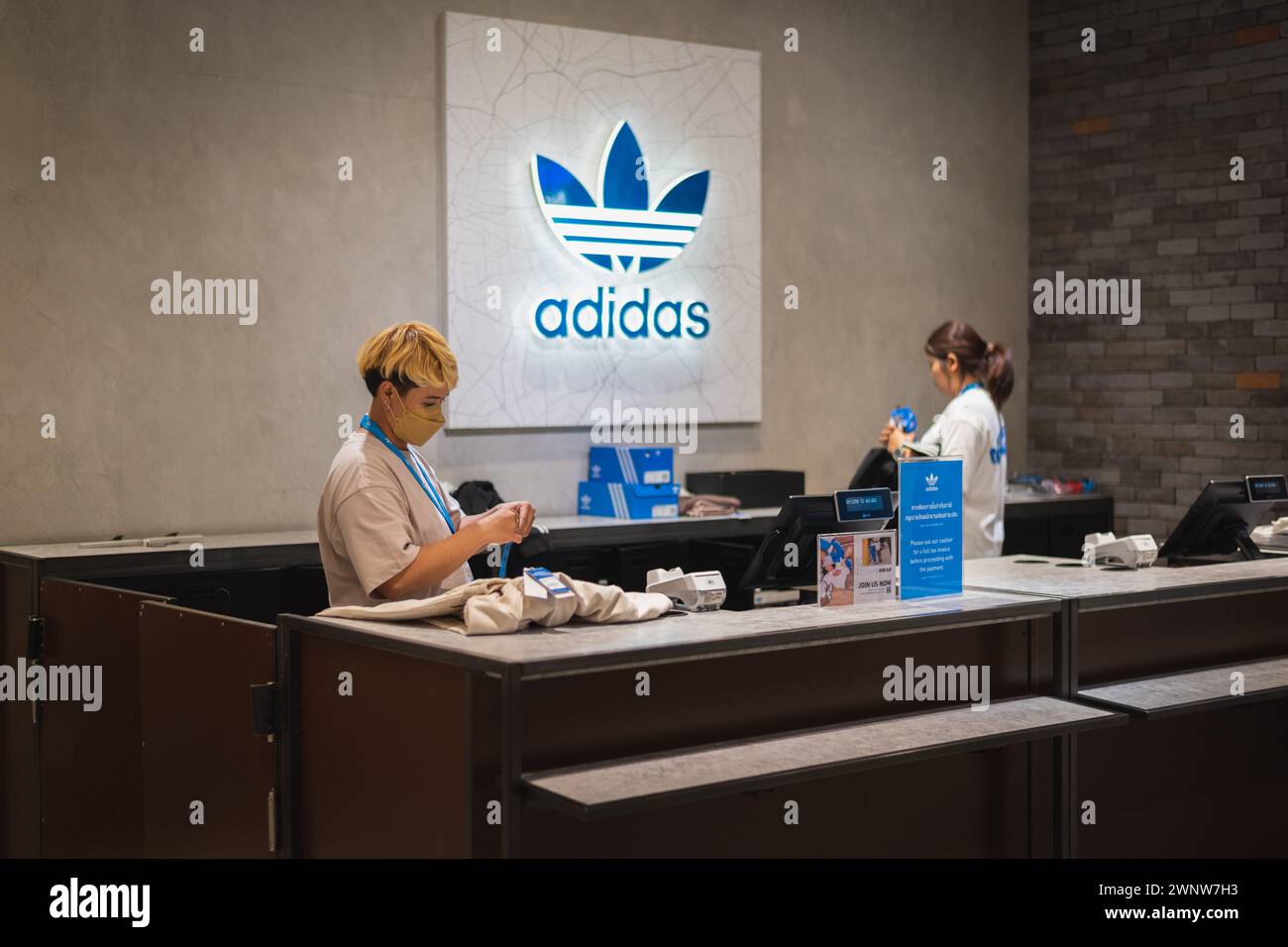 Bangkok, Thailand - December 10, 2023: cashiers at cashier counter at Adidas store. Stock Photo