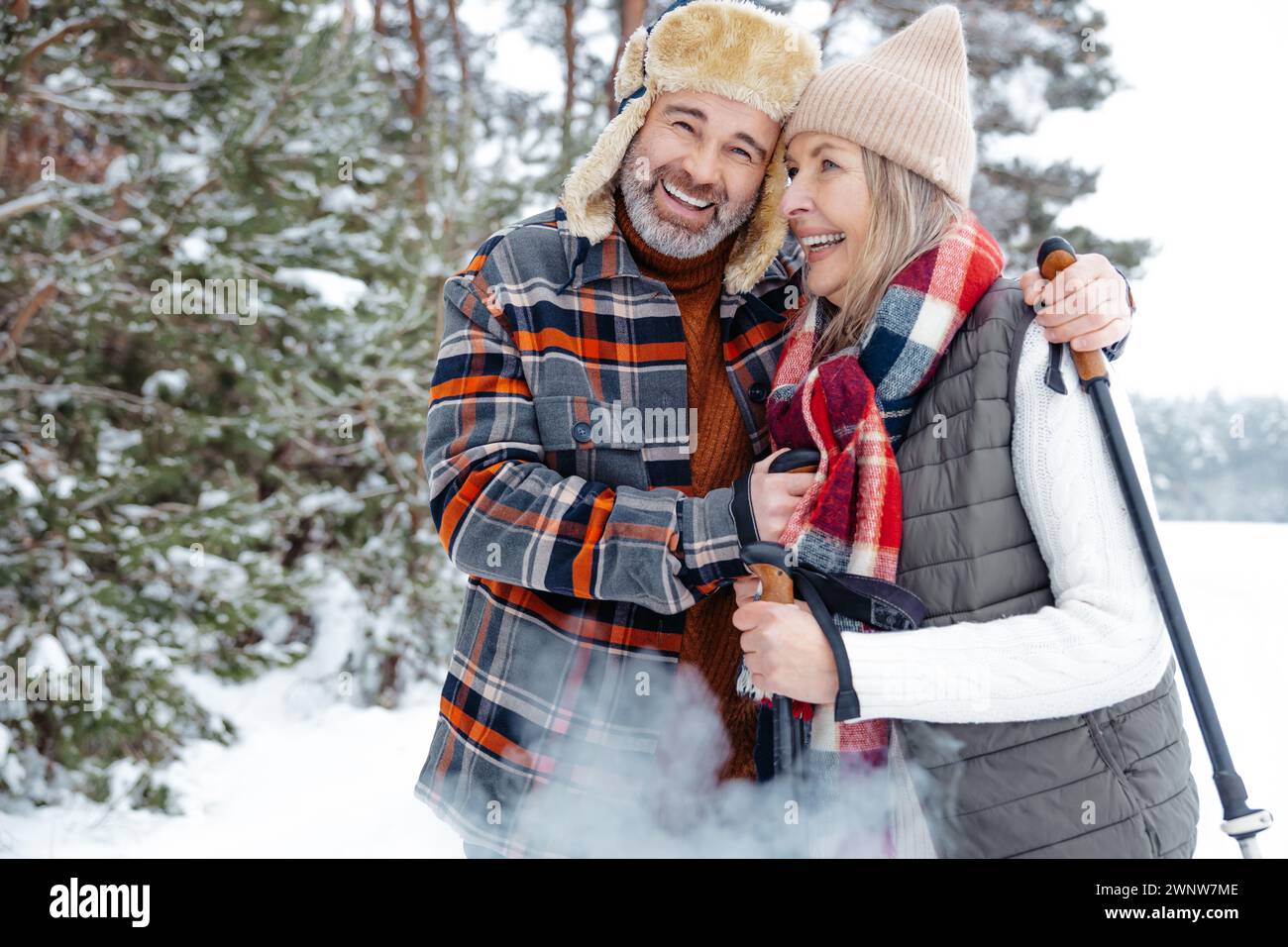 Happy mature couple with scandinavian stick on a walk in a forest Stock ...