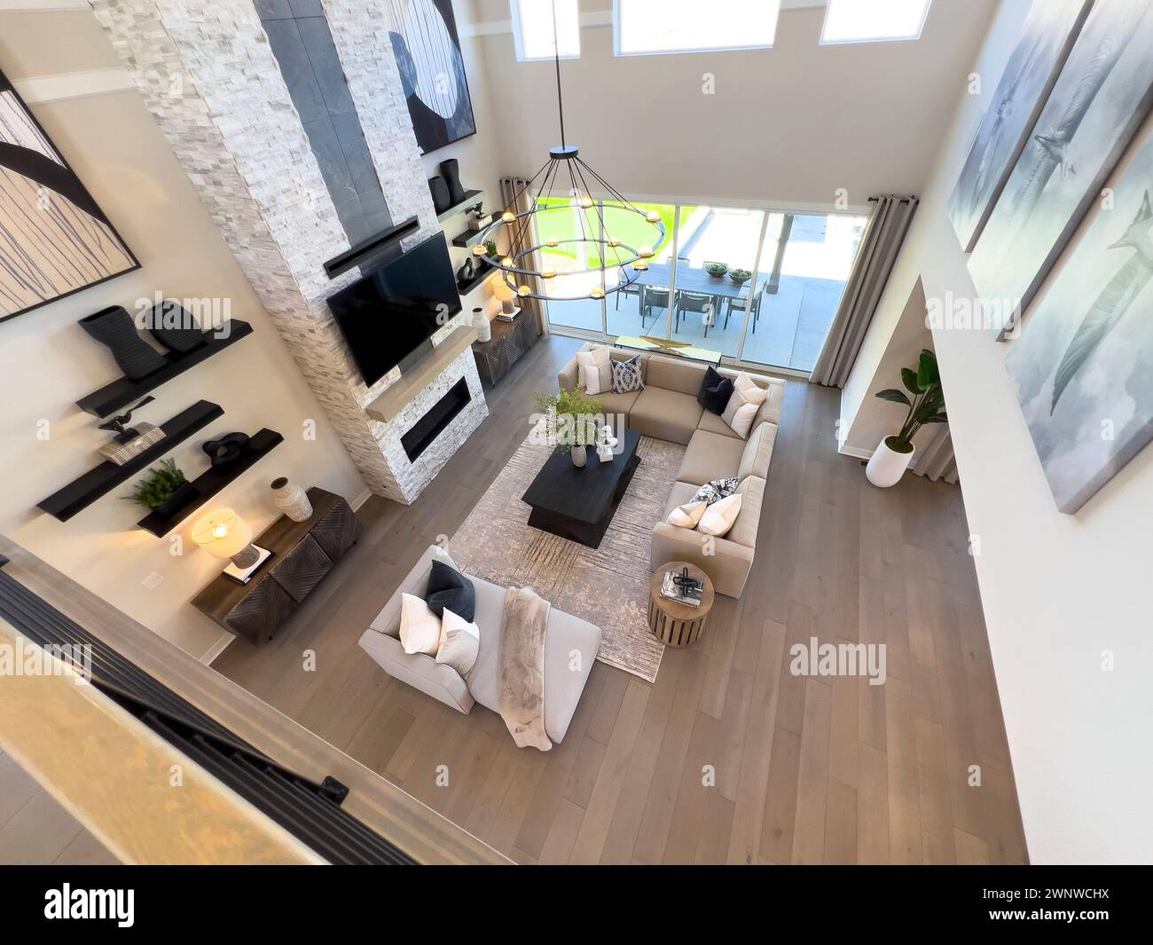 Luxurious Two-Story Living Room with Modern Fireplace and Chic Decor ...
