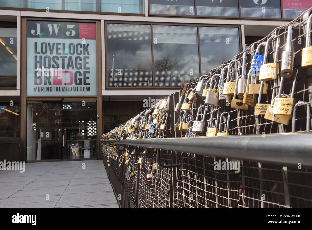 JW3 Lovelock Hostage Bridge that links the centre with Finchley Road, fitted with over 100 padlocks signed by Israel hostages' family members & high profile personalities to highlight the ongoing plight of the hostages, and call for their release and peace, north London, UK Stock Photo