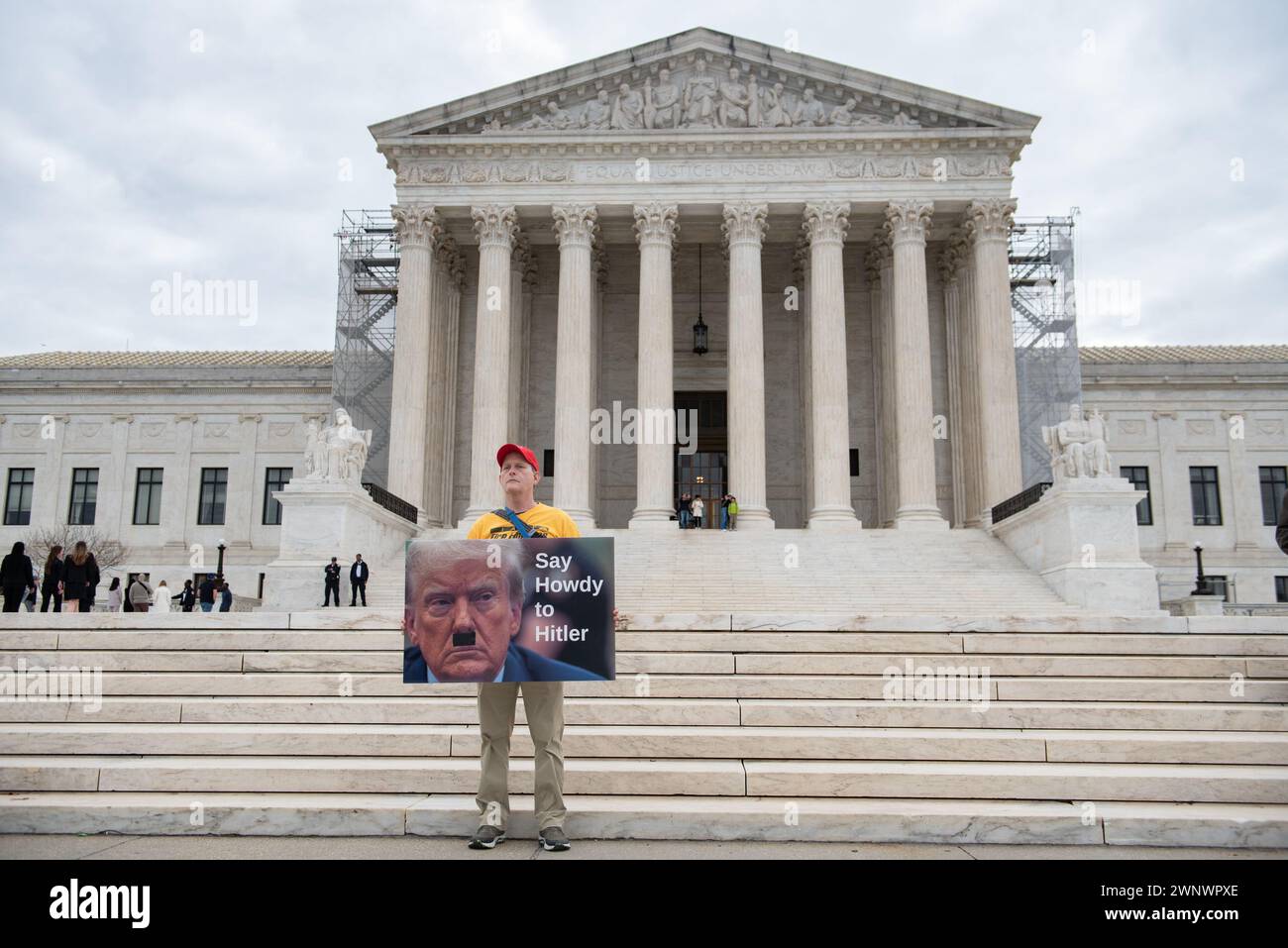 A person stands outside with a sign during the Supreme Court ruling on