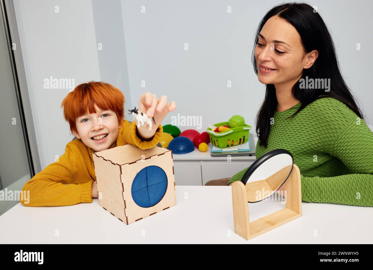 Mental health for kids. Professional kids psychologist working with cute male child in office during play therapy session Stock Photo