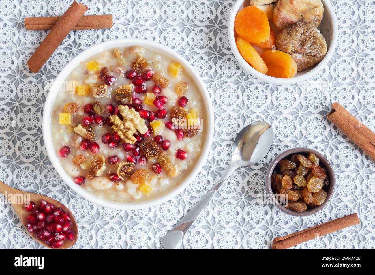 Traditional Turkish delicious mixed dessert, ashura (asure) with pomegranate seeds, walnut, apricot, Noah’s pudding Stock Photo