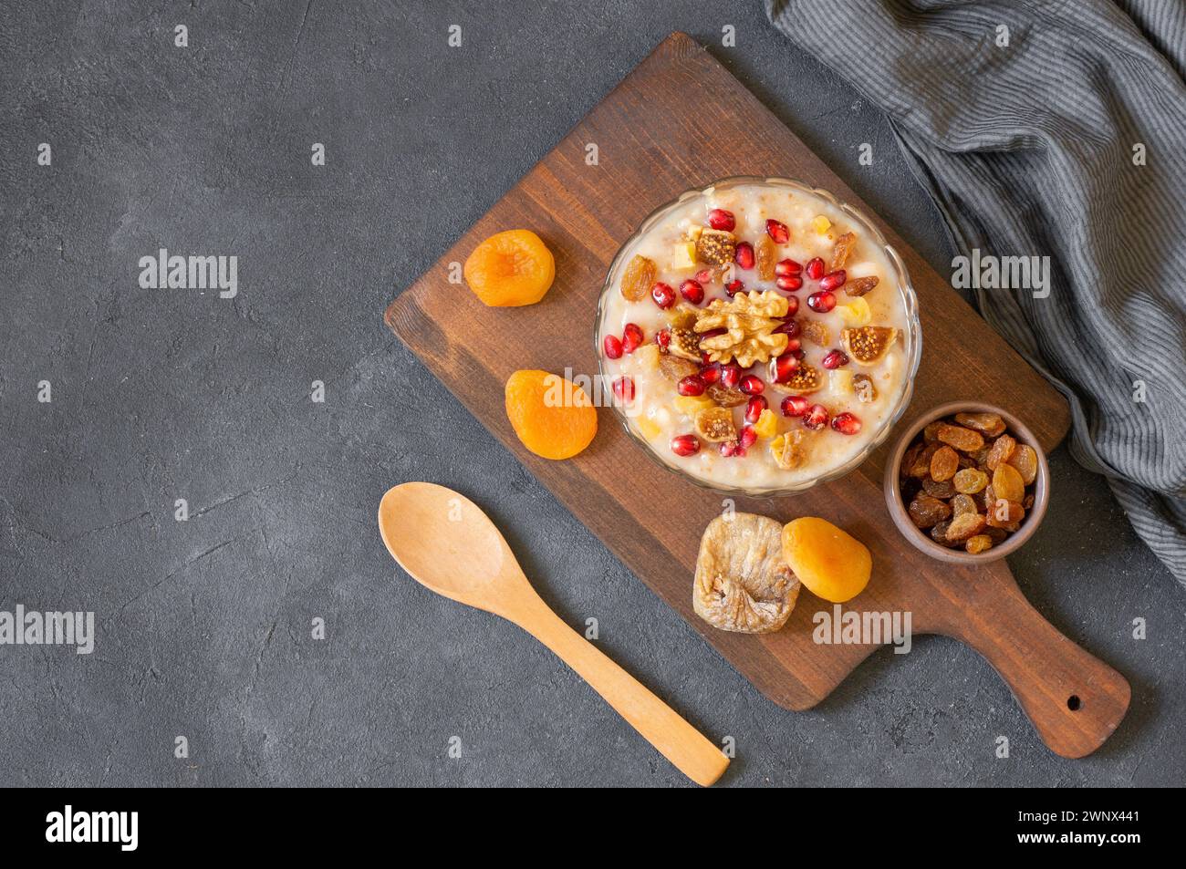 Traditional Turkish delicious mixed dessert, ashura (asure) with pomegranate seeds, walnut, apricot, Noah’s pudding Stock Photo