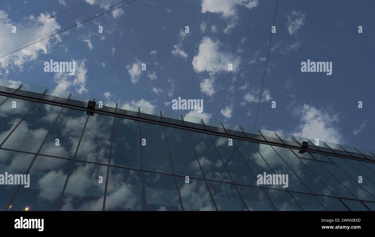 The sky and glass facade of the building. Reflection of the blue sky ...