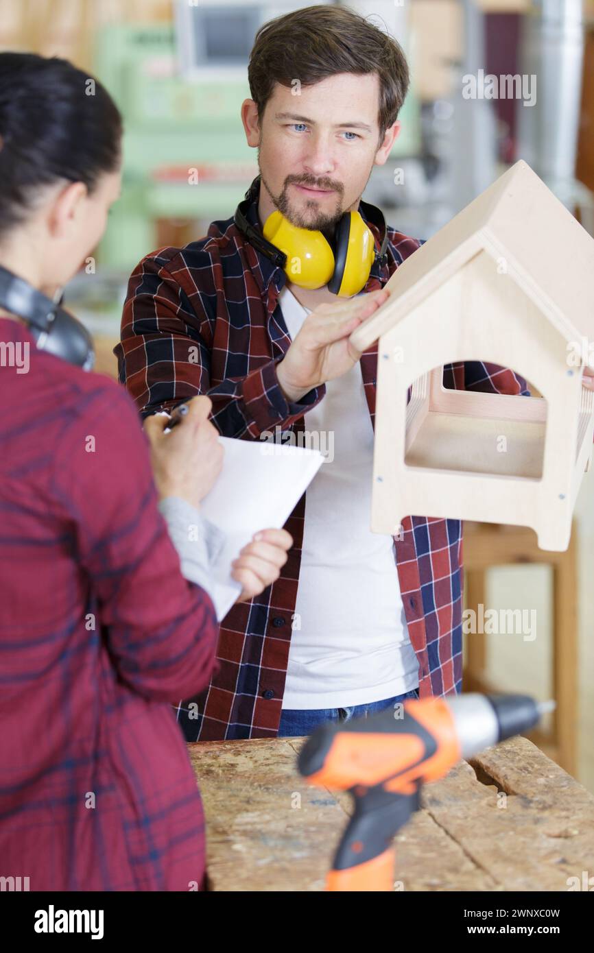 carpenter in workshop making a birdhouse Stock Photo